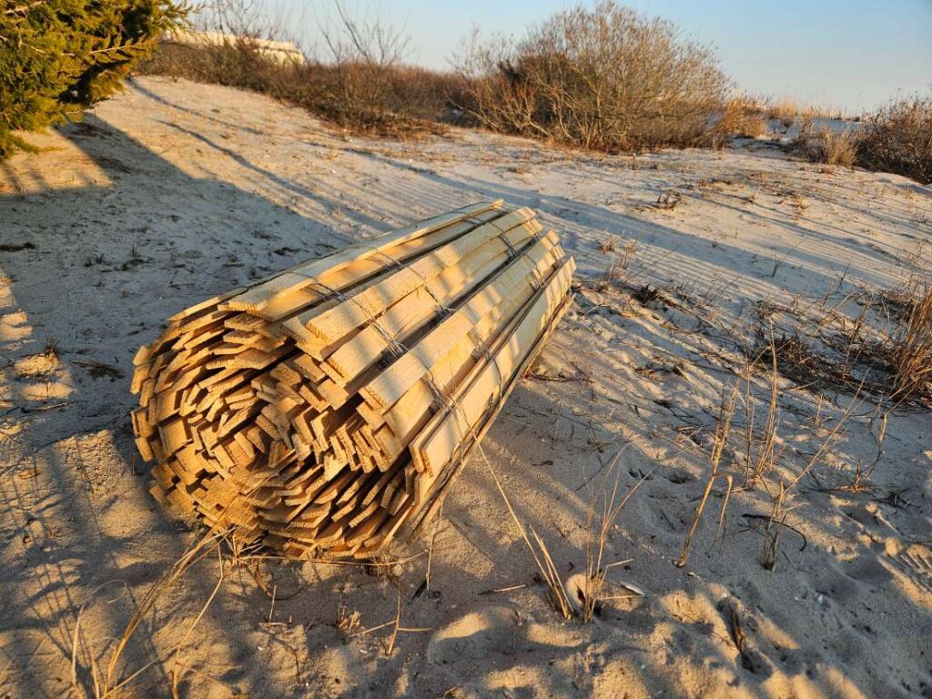 Rolled wood slat dune fence at an Ocean County private beach